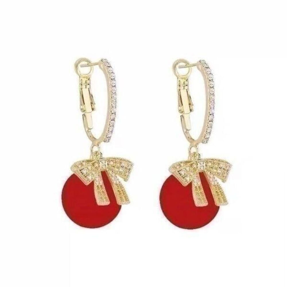 Red ornamental ball and crystal bow dangle gold holiday earrings.